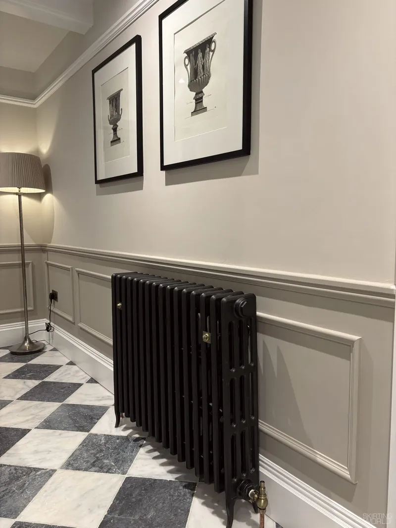 Edwardian MDF skirting board with pale grey panelling and architrave in a hallway.